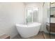Luxurious bathroom with free standing tub, large window, and designer accent tiles at 3934 Sangre De Cristo Ave, Las Vegas, NV 89118