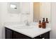 Bathroom featuring a white counter and dark wood cabinets, mirror, and bronze accessories at 3934 Sangre De Cristo Ave, Las Vegas, NV 89118