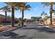Gated community entrance with mature palm trees and meticulously maintained landscaping at 3934 Sangre De Cristo Ave, Las Vegas, NV 89118