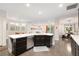 Modern kitchen island with sleek countertops and dark cabinetry, seamlessly flowing into dining and living areas at 3934 Sangre De Cristo Ave, Las Vegas, NV 89118