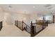 Neutral carpeted landing overlooking the lower level featuring modern wrought iron railings and an open floorplan at 3934 Sangre De Cristo Ave, Las Vegas, NV 89118