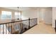 Neutral carpeted landing overlooking the lower level featuring modern wrought iron railings and bright natural light at 3934 Sangre De Cristo Ave, Las Vegas, NV 89118