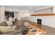 Spacious living room featuring a white brick fireplace, grey sofa, and an open layout to the kitchen at 3934 Sangre De Cristo Ave, Las Vegas, NV 89118