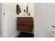 Stylish powder room with a modern floating vanity, round mirror, and contemporary fixtures for added elegance at 3934 Sangre De Cristo Ave, Las Vegas, NV 89118