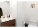 Elegant powder room featuring a modern vanity with a white sink and wooden cabinets, and modern fixtures at 3934 Sangre De Cristo Ave, Las Vegas, NV 89118