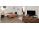 Modern studio apartment featuring a comfortable bed, small couch, and a television with lots of natural light at 3934 Sangre De Cristo Ave, Las Vegas, NV 89118