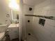 Modern bathroom featuring subway tile shower, patterned tile floors, and white vanity at 4030 E Carey Ave, Las Vegas, NV 89115