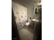 Bathroom featuring a shower/tub combo, pedestal sink, and tiled floor at 4030 E Carey Ave, Las Vegas, NV 89115
