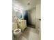 Tiled bathroom features a shower with pebble floor and single sink vanity at 4030 E Carey Ave, Las Vegas, NV 89115