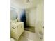 Bathroom with neutral walls, vanity with countertop, and shower with tile surround at 4030 E Carey Ave, Las Vegas, NV 89115