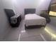Tile bedroom with white walls and black dresser and gray bed frame at 4030 E Carey Ave, Las Vegas, NV 89115