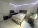 Tile bedroom with LED lighting and a black dresser and gray bed frame at 4030 E Carey Ave, Las Vegas, NV 89115