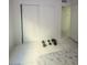 White tiled bedroom with weights and mirrored closet doors at 4030 E Carey Ave, Las Vegas, NV 89115