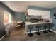 Kitchen with wood floors, bar seating, stainless steel refrigerator and adjacent dining area at 4030 E Carey Ave, Las Vegas, NV 89115