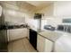 Bright kitchen featuring white cabinets, granite countertops and views of the living space at 4030 E Carey Ave, Las Vegas, NV 89115
