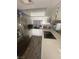 An inviting kitchen is shown with a tile backsplash and stainless steel refrigerator at 4030 E Carey Ave, Las Vegas, NV 89115