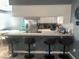 Beautiful kitchen with seating, white cabinets, modern appliances, and a quartz countertop at 4030 E Carey Ave, Las Vegas, NV 89115