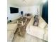 Bright living room with a large TV, a sectional sofa, an accent rug and modern floors at 4030 E Carey Ave, Las Vegas, NV 89115