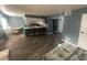 Open-concept living room and kitchen area features a breakfast bar and wood floors at 4030 E Carey Ave, Las Vegas, NV 89115