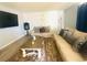 Comfortable living room with neutral tones, a big screen TV, a sectional sofa and accent lighting at 4030 E Carey Ave, Las Vegas, NV 89115