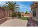 Private backyard with brick wall, landscaped area, and hardscape at 4140 Gliding Gulls Ave, North Las Vegas, NV 89084