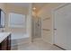 Bright bathroom features a soaking tub and glass enclosed shower with white tile surround at 4140 Gliding Gulls Ave, North Las Vegas, NV 89084