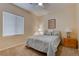 Cozy bedroom features a ceiling fan and neutral decor at 4140 Gliding Gulls Ave, North Las Vegas, NV 89084