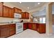 Open concept kitchen with white appliances and view of the living area at 4140 Gliding Gulls Ave, North Las Vegas, NV 89084