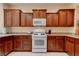 Traditional kitchen with granite countertops and natural wood cabinets at 4140 Gliding Gulls Ave, North Las Vegas, NV 89084