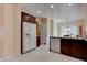 Bright kitchen featuring white appliances and tile flooring at 4140 Gliding Gulls Ave, North Las Vegas, NV 89084