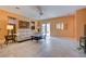 Bright living room with a comfortable sofa and sliding glass doors at 4140 Gliding Gulls Ave, North Las Vegas, NV 89084