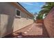 View of the side yard featuring a red rock landscape and block wall at 4140 Gliding Gulls Ave, North Las Vegas, NV 89084