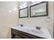 Modern bathroom featuring double sinks, framed mirrors, and updated fixtures for a spa-like experience at 417 Wisteria Ave, Las Vegas, NV 89107
