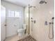 Bright bathroom featuring a shower with multiple heads, and a toilet, offering a spa-like experience at 417 Wisteria Ave, Las Vegas, NV 89107