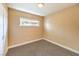 Cozy bedroom with neutral walls, carpet flooring, ample natural light from the window, and a closet at 417 Wisteria Ave, Las Vegas, NV 89107