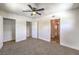 Bright bedroom with neutral carpet, ceiling fan, and ample closet space providing comfort and functionality at 417 Wisteria Ave, Las Vegas, NV 89107