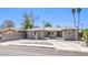 Charming single-story home with gray exterior paint, well-manicured landscaping, and a circular driveway at 417 Wisteria Ave, Las Vegas, NV 89107