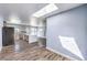 Open-concept kitchen and living area with sleek appliances, a skylight, and an island at 417 Wisteria Ave, Las Vegas, NV 89107