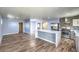 Modern kitchen boasts stainless steel appliances, a large island, and hardwood floors, creating a perfect culinary space at 417 Wisteria Ave, Las Vegas, NV 89107