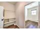 Convenient laundry room with a stackable washer and dryer, shelving, and access to an additional storage area at 417 Wisteria Ave, Las Vegas, NV 89107