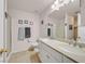 Bright bathroom featuring a double sink vanity, tile floors, and shower at 421 Engel Ave, Henderson, NV 89011