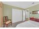 This is a charming bedroom featuring a built-in closet with white sliding doors at 421 Engel Ave, Henderson, NV 89011