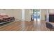 Spacious living room with wood floors, natural light, and backyard access at 421 Engel Ave, Henderson, NV 89011