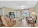 Cozy living room featuring wood flooring, comfortable seating and natural light from a window at 421 Engel Ave, Henderson, NV 89011