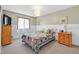 Comfortable bedroom with a bed, dresser, carpet and a light-filled window at 421 Engel Ave, Henderson, NV 89011