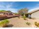 Spacious backyard with low maintenance desert landscaping featuring mature shade trees, cacti, and rock ground cover at 435 Piute Valley Ct, Henderson, NV 89012