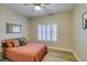 Bedroom featuring a cozy bed and window with plantation shutters and a ceiling fan at 435 Piute Valley Ct, Henderson, NV 89012