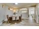 Bright dining room with wood floors and an open layout to the kitchen at 435 Piute Valley Ct, Henderson, NV 89012