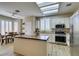 Bright kitchen features a center island with butcher block top, white cabinetry, and stainless steel appliances at 435 Piute Valley Ct, Henderson, NV 89012
