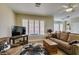 Bright living room featuring plantation shutters, neutral tones, and wood-look flooring at 435 Piute Valley Ct, Henderson, NV 89012